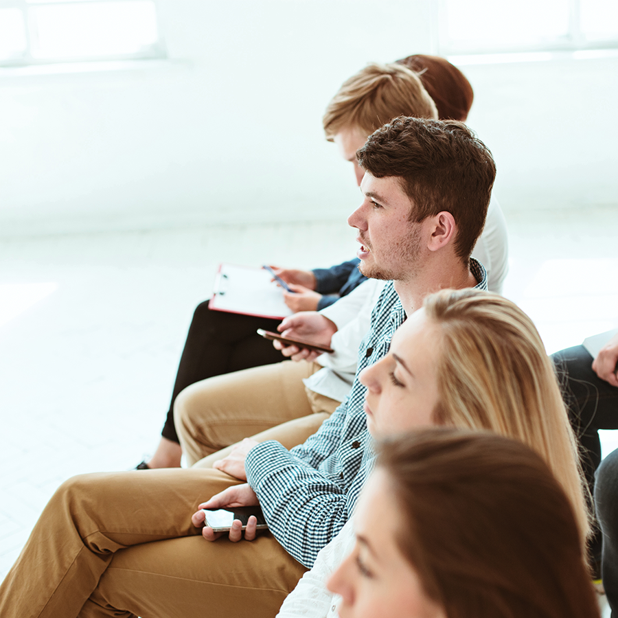 Women Performing Yoga on Green Grass Near Trees